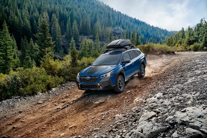 Subaru Outback station wagon off road, descending a hill