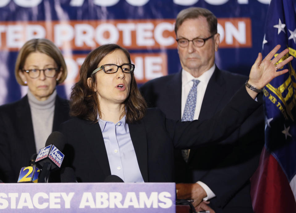 Lauren Groh-Wargo, Stacey Abrams' campaign manager, standing with attorneys at a press conference today, discussed the Abrams campaign's pending legal actions. After declaring the race for governor over, Republican Brian Kemp met with Gov. Nathan Deal on Thursday to start the work of transitioning his executive team. But Stacey Abrams is not conceding anything yet, hopeful that a trove of provisional ballots could be enough to swing the race into a runoff. Her campaign unveiled a litigation team poised to take the fight to the legal system, and says an additional 25,632 Abrams votes will push this race into runoff territory. (Bob Andres/Atlanta Journal-Constitution via AP)