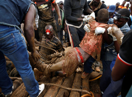 A rescued artisanal miner is carried from a pit as retrieval efforts proceed for trapped illegal gold miners in Kadoma, Zimbabwe, February 16, 2019. REUTERS/Philimon Bulawayo