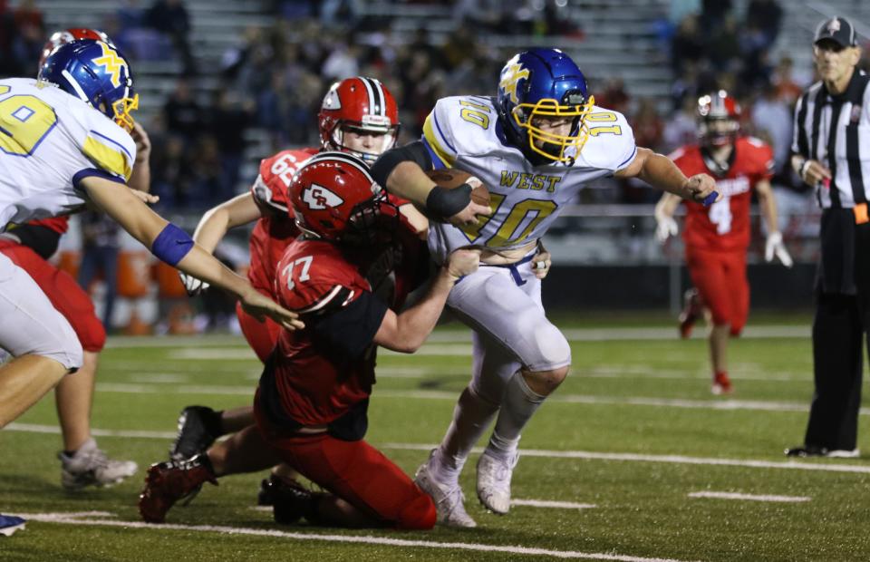 West Muskingum's Harley Hopkins fights for yardage against Coshocton. Hopkins earned first-team honors in Division V.