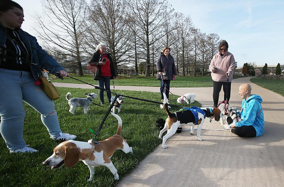 Dogs approch to Ally Arabio (right) while visiting at Reiman Gardens during the Rovers at Reiman every Tuesday evening on April 18, 2023, in Ames, Iowa.