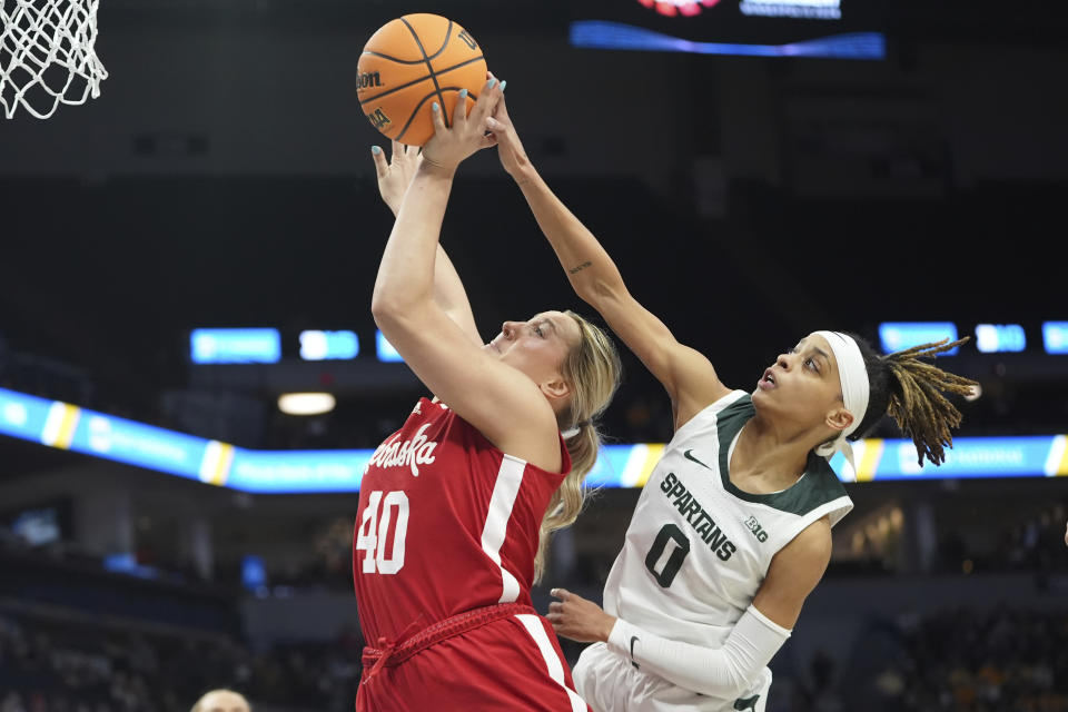 Nebraska center Alexis Markowski (40) shoots as Michigan State guard DeeDee Hagemann (0) defends during the first half of an NCAA college basketball quarterfinal game at the Big Ten women's tournament Friday, March 8, 2024, in Minneapolis. (AP Photo/Abbie Parr)