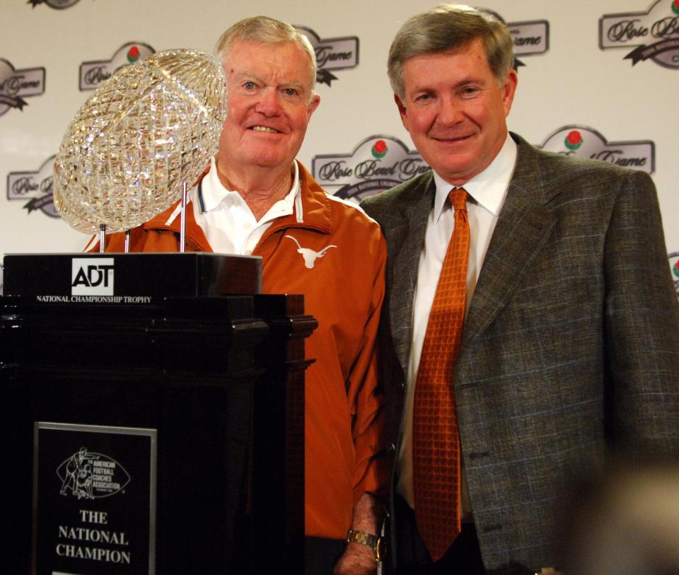 Mack Brown, right, and fellow Texas coaching legend Darrell Royal check out the trophy before the national championship win over USC. Brown led the Horns to their first national title in 35 seasons. Texas was runner-up to Alabama four years later.