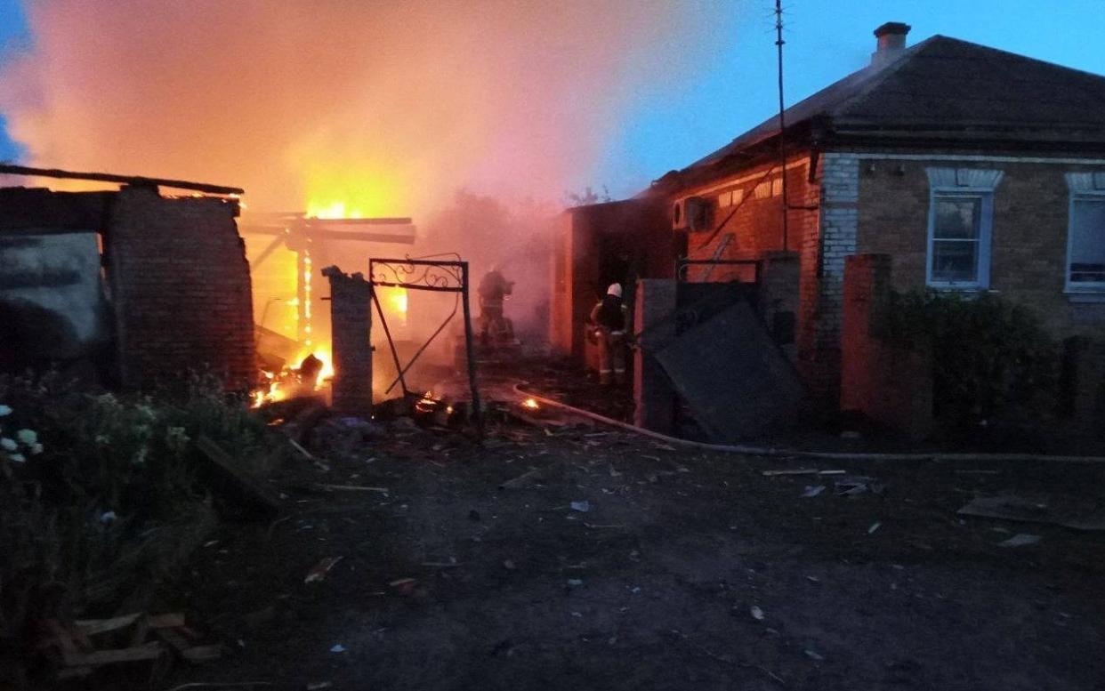 Firefighters work at a house on fire following shelling in Belgorod - Reuters