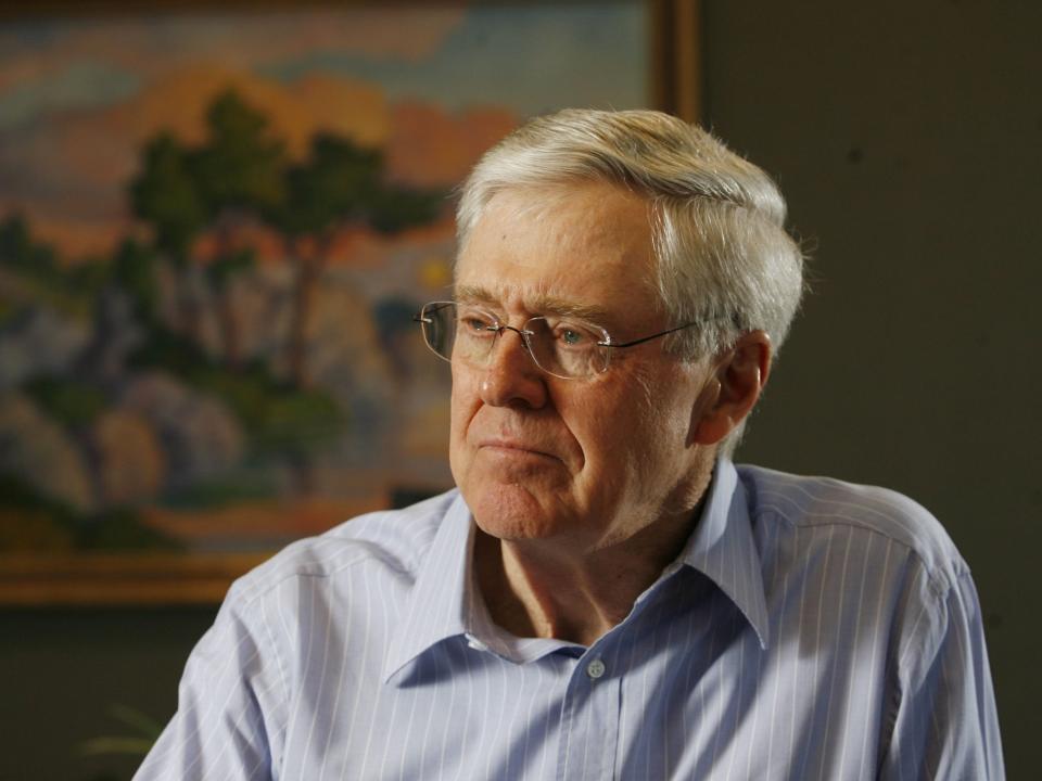 Charles Koch poses for a photograph looking off frame.