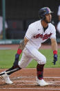 Cleveland Indians' Eddie Rosario watches his RBI single during the first inning of the team's baseball game against the Seattle Mariners, Friday, June 11, 2021, in Cleveland. (AP Photo/Tony Dejak)