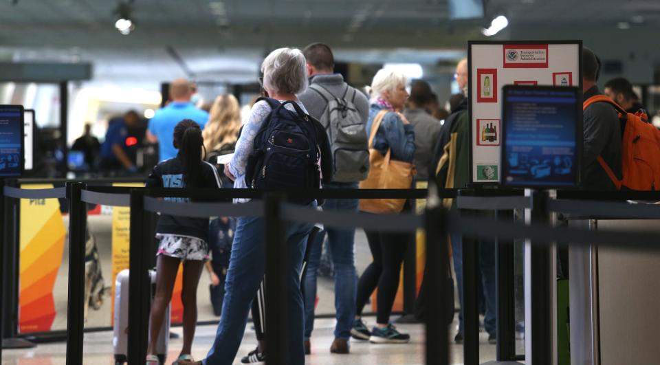People stand in line for security screening at the Louisville (Ky.) Muhammad Ali International Airport Friday, April 29, 2022.