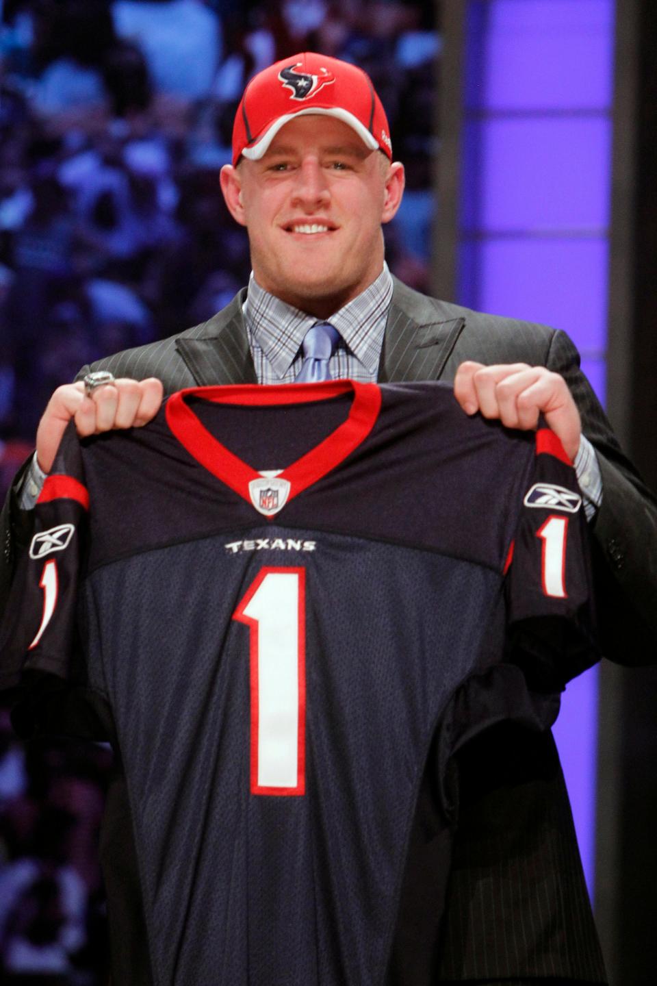 J.J. Watt holds up a jersey after he was selected as the 11th overall pick by the Houston Texans in the first round of the 2011 NFL draft at Radio City Music Hall in New York. He has authored a Hall of Fame career.