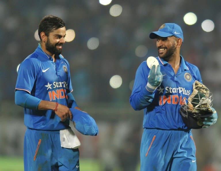 India's Mahendra Singh Dhoni (R) and Virat Kohli walk back to the pavilion after winning their ODI match against New Zealand, in Visakhapatnam, in October 2016