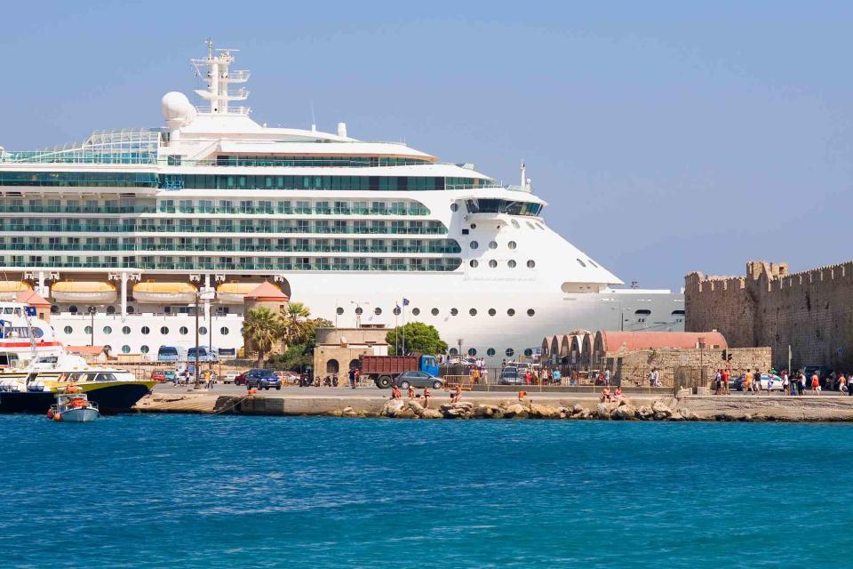 <p>Glowimages/Getty Images</p> Cruise ship docked in Rhodes, Greece.