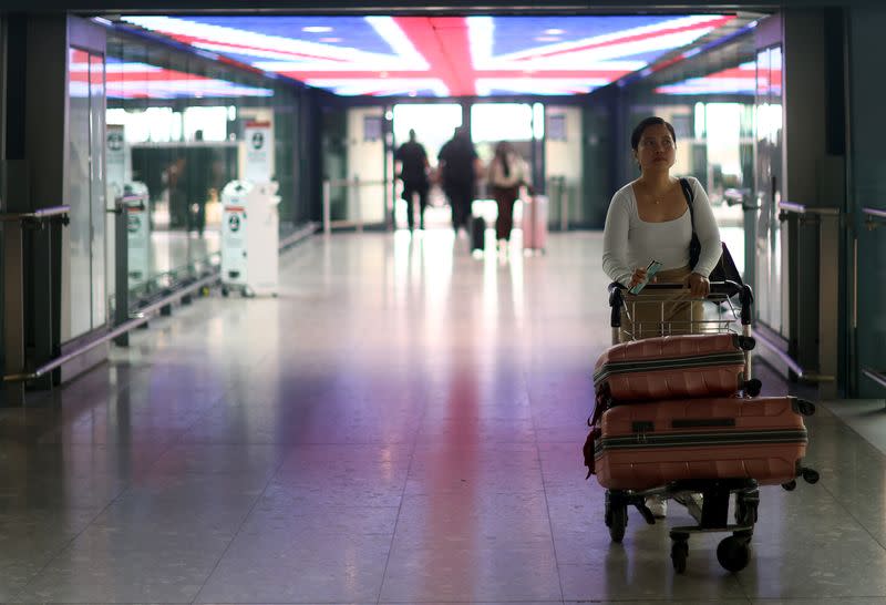 Passengers wait at Heathrow Terminal 5 airport