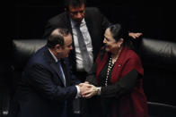 Guatemala's President Alejandro Giammattei shakes hands with Mexican Senate President Monica Fernandez Balboa after addressing the senate members in Mexico City, Thursday, Feb. 6, 2020. (AP Photo/Rebecca Blackwell)