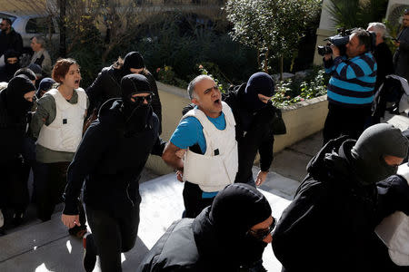 Eight men and a woman holding Turkish citizenship, who were arrested on suspected links to a leftist militant group outlawed in Turkey following an operation by Greek security services, are escorted by anti-terrorism police officers to the prosecutor's office in Athens, Greece, November 29, 2017. REUTERS/Alkis Konstantinidis