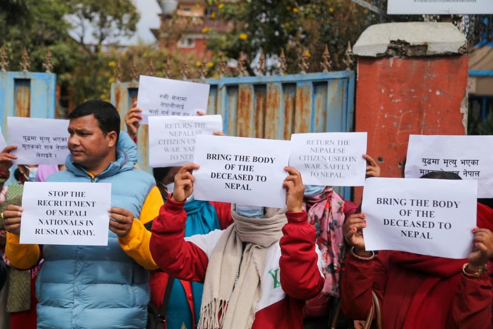 Family members and returnees from the Russian Army are demonstrating near the Russian Embassy in Kathmandu, Nepal, on Feb. 6, 2024. Dozens of Nepalis have been killed and scores injured while fighting on the front lines in the war against Ukraine. The demonstrators are submitting a letter to the Russian Embassy officials, requesting Russia to stop the recruitment of Nepali citizens as soldiers in their forces with the promise of a handsome salary. (Subaas Shrestha/NurPhoto via Getty Images)