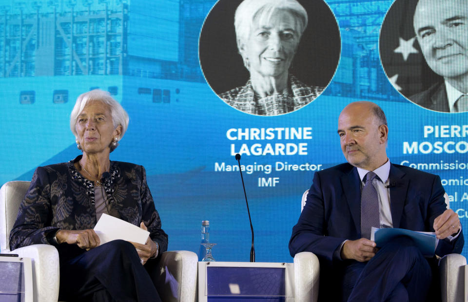 Managing Director of International Monetary Fund (IMF) Christine Lagarde, left, and European Commissioner for Economic and Financial Affairs Pierre Moscovici attend a seminar in Bali, Indonesia, Wednesday, Oct. 10, 2018. (AP Photo/Firdia Lisnawati)