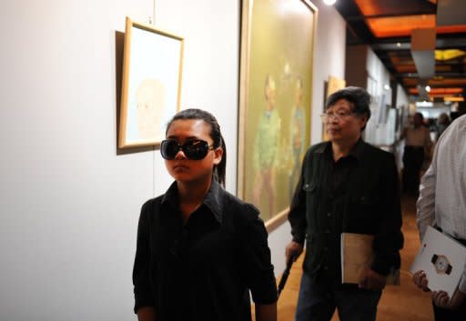 Visitors are seen browsing art work at a preview show of an auction house in Beijing, in May. Until recently, few in the art world had even heard of China's auction houses. Today, they are among the world's biggest by revenue, posing a serious challenge to the likes of Sotheby's and Christie's