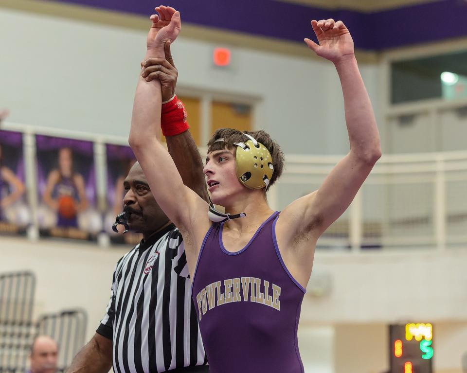 Fowlerville's Jesse Johnson pinned state-ranked Victor Radu of Chelsea at 144 pounds to break a tie in a 46-19 victory in the district final on Wednesday, Feb. 8, 2023.