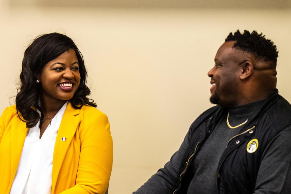 Democratic candidate for governor Deidre DeJear, left, smiles while speaking with Bruce Teague, mayor of Iowa City, during the Black and Brown Town Hall, Friday, Oct. 28, 2022, at the Iowa City Public Library in Iowa City, Iowa.