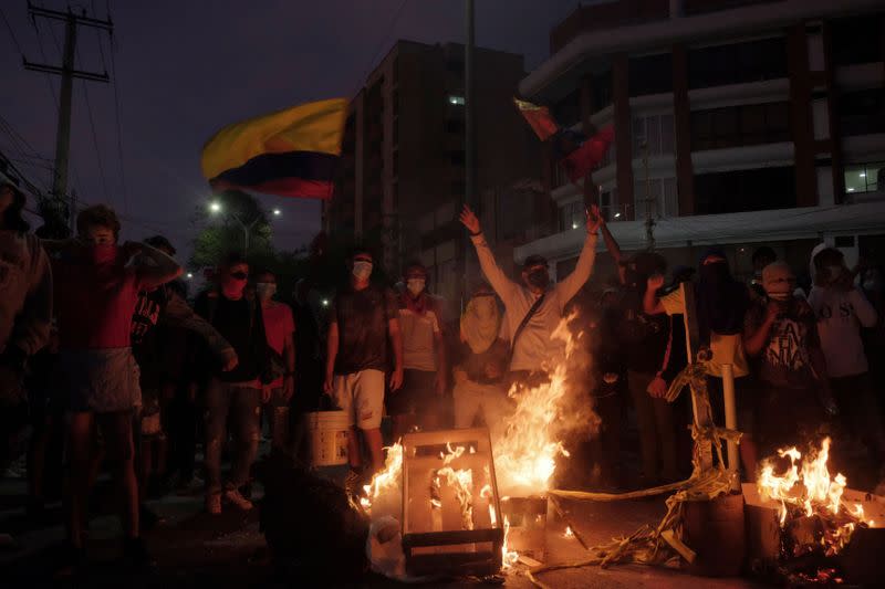 Manifestantes reunidos alrededor de una barricada en llamas durante una protesta contra un partido de fútbol de la Copa Libertadores entre el América de Cali y el Atlético Mineiro que se detuvo varias veces ya que los jugadores se vieron afectados por los gases lacrimógenos disparados fuera del Estadio Olímpico Romelio Martínez, en Barranquilla