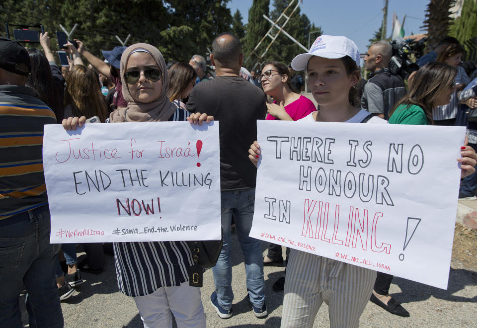 Two Palestinian women hold placards during a rally in front of the Prime Minister's office, in the West Bank city of Ramallah, Monday, Sept. 2. 2019. Hundreds of Palestinian women protested in front of the prime minister's office to demand an investigation into the death of Israa Ghrayeb, a 21-year-old woman whom many suspect was the victim of a so-called honor killing. (AP Photo/Nasser Nasser)