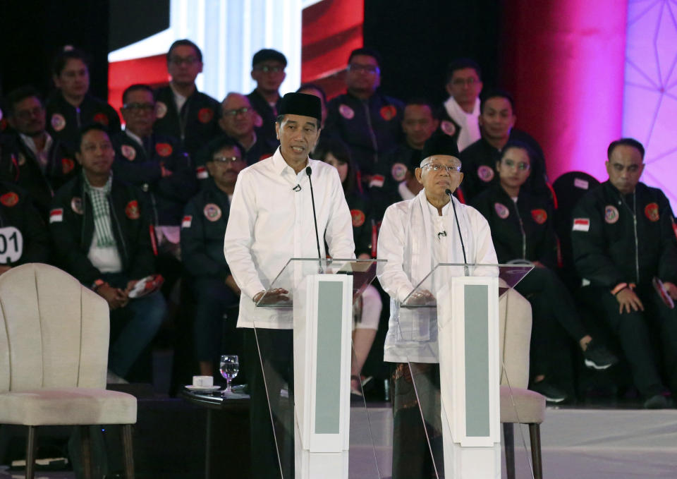 Indonesian President Joko Widodo, left, delivers a speech with running mate Ma'ruf Amin, right, during a televised debate in Jakarta, Indonesia, Thursday, Jan. 17, 2019. Indonesia is gearing up to hold its presidential election on April 17 that will pit in the incumbent against the former general.(AP Photo / Tatan Syuflana)