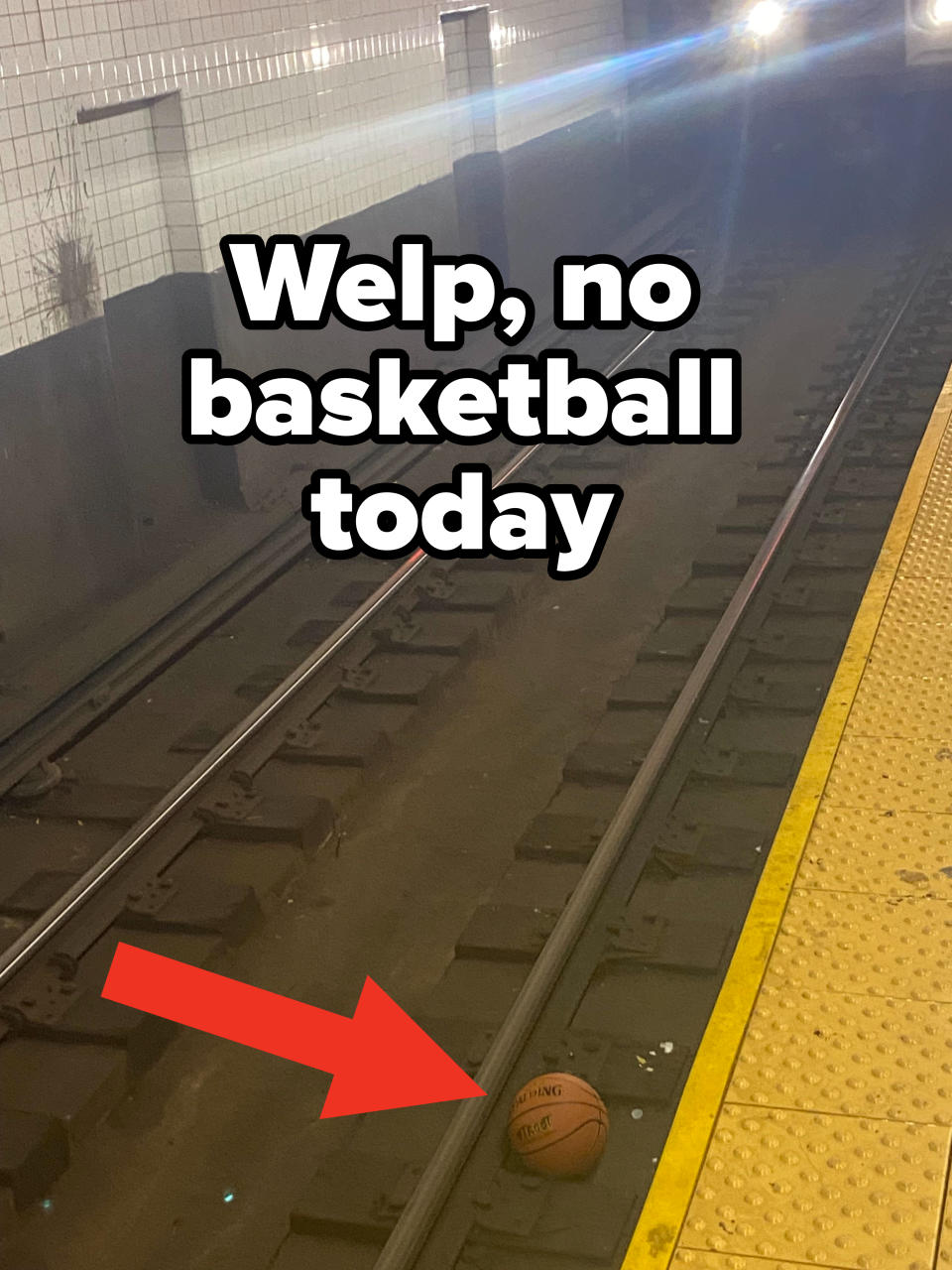 a basketball on a subway track