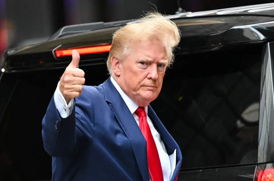 Former President Donald Trump, with wind-blown hair, leaves Trump Tower to meet with New York Attorney General Letitia James for a civil investigation.