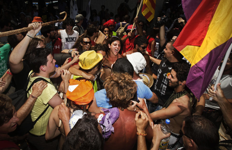 Protesters meet after traveling to Madrid from many parts of Spain to demonstrate against the country's near 25 percent unemployment rate and stinging austerity measures introduced by the government in Madrid, Spain, Saturday, July 21, 2012. (AP Photo/Andres Kudacki)