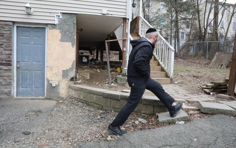 Property Manager Joel Fisher visits houses next to a two-family house where there was a fatal fire on Lake St. in Spring Valley March 6, 2023.