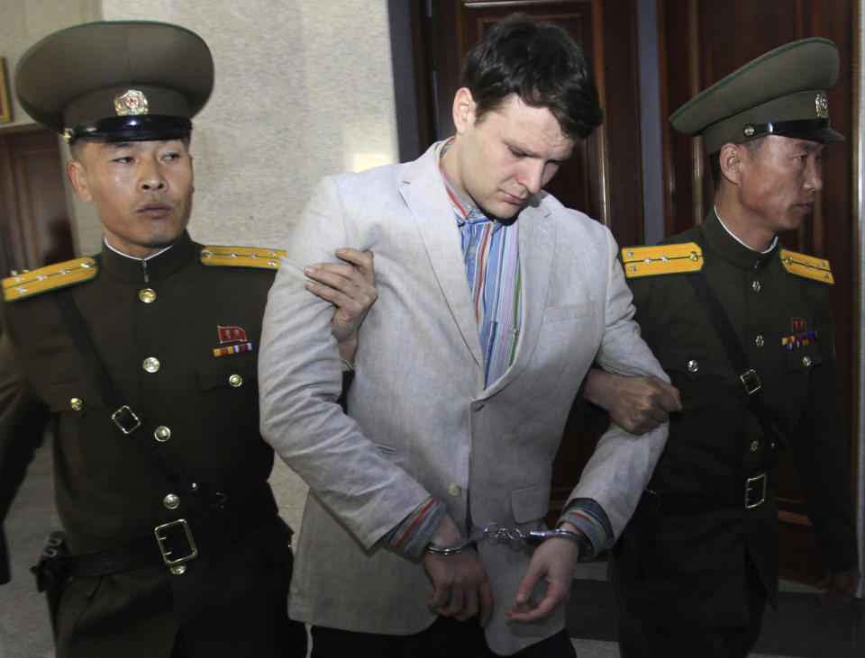 FILE - In this March 16, 2016, file photo, American student Otto Warmbier, center, is escorted at the Supreme Court in Pyongyang, North Korea. President Donald Trump says he doesn't think North Korean leader Kim Jong Un was involved in the mistreatment of American college student Otto Warmbier, who died after being detained in the North. Trump says of Kim: "He tells me that he didn't know about it, and I will take him at his word." The Ohio native was sentenced to 15 years of hard labor in North Korea on suspicion of stealing a propaganda poster. Warmbier died in 2017, shortly after being sent home in a coma. (AP Photo/Jon Chol Jin, File)