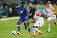 Hoffenheim's Ihlas Bebou, left, and Leipzig's Castello Lukeba battle for the ball during the Bundesliga soccer match between TSG 1899 Hoffenheim and RB Leipzig at PreZero Arena, Sinsheim, Germany, Friday May 3, 2024. (Uwe Anspach/dpa via AP)