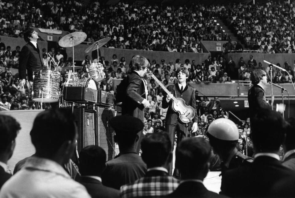 The Beatles perform at the Seattle Center Coliseum in Washington during their Summer 1964 United States and Canada Tour, 21 August 1964 (Getty)
