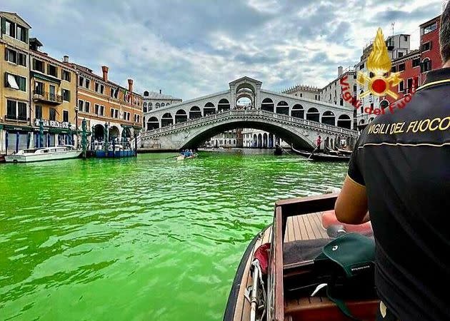The Grand Canal turned bright green near the Rialto Bridge in Venice, Italy on May 28, 2023. 