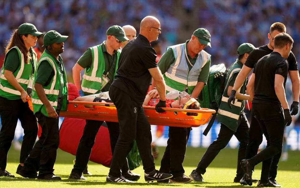 Luton Town's Tom Lockyer leaves the pitch on a stretcher after becoming injured during the Sky Bet Championship play-off final at Wembley - Tom Lockyer celebrates Luton’s promotion from hospital bed - PA/Adam Davy