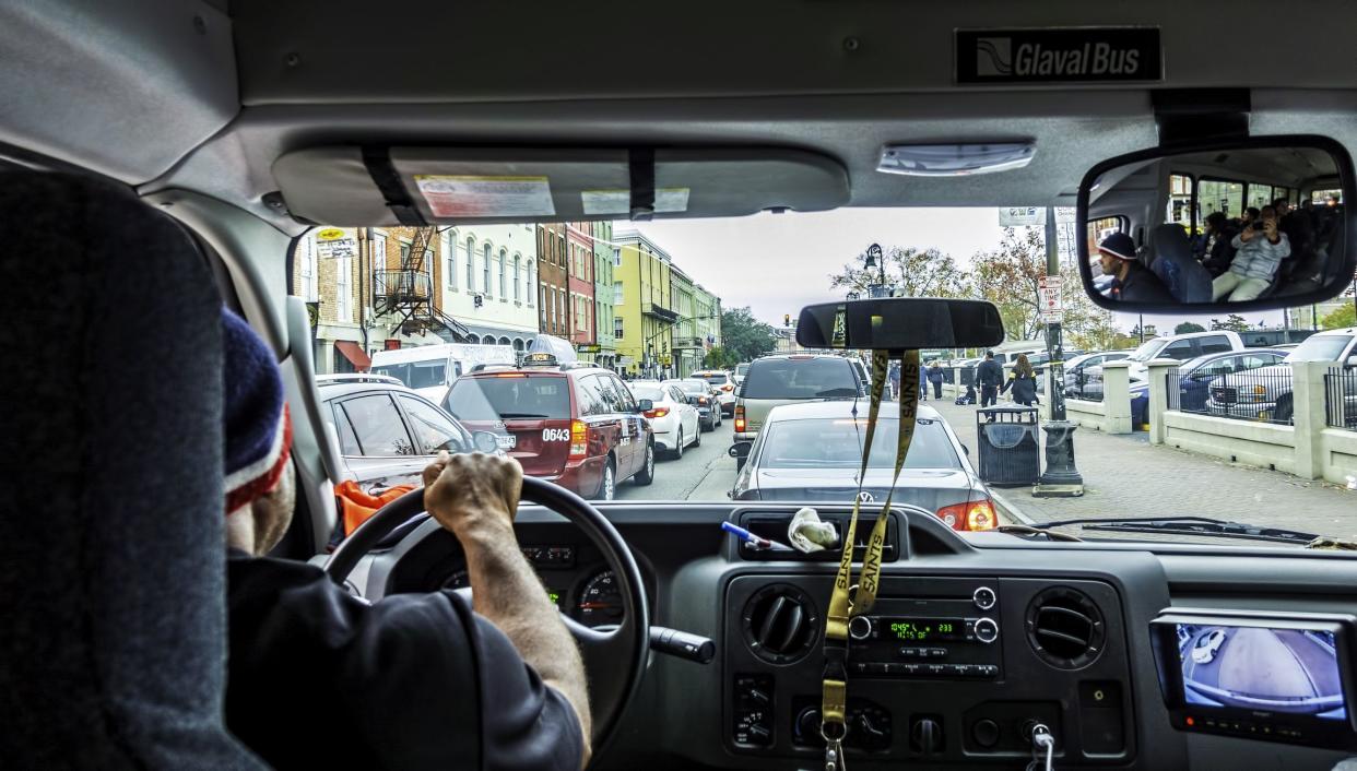 New Orleans, USA - Dec 17, 2017: Looking out from a mini tour bus, traveling along Decatur Street in the French Quarter. Vehicle traffic congestion can be seen through the windscreen.
