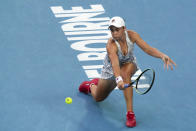 Ash Barty of Australia makes a backhand return to Amanda Anisimova of the U.S. during their fourth round match at the Australian Open tennis championships in Melbourne, Australia, Sunday, Jan. 23, 2022. (AP Photo/Simon Baker)