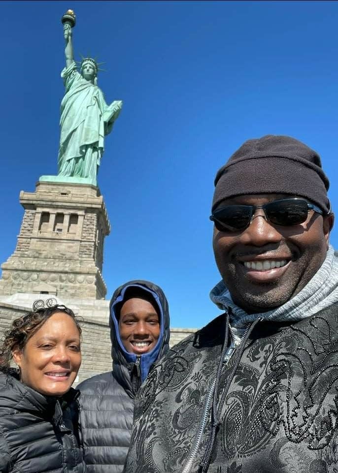 Donald Jordan and family at the Statue of Liberty in New York City. Jordan was the brainchild of a documentary on Black fatherhood, titled "Presence Over Presents."