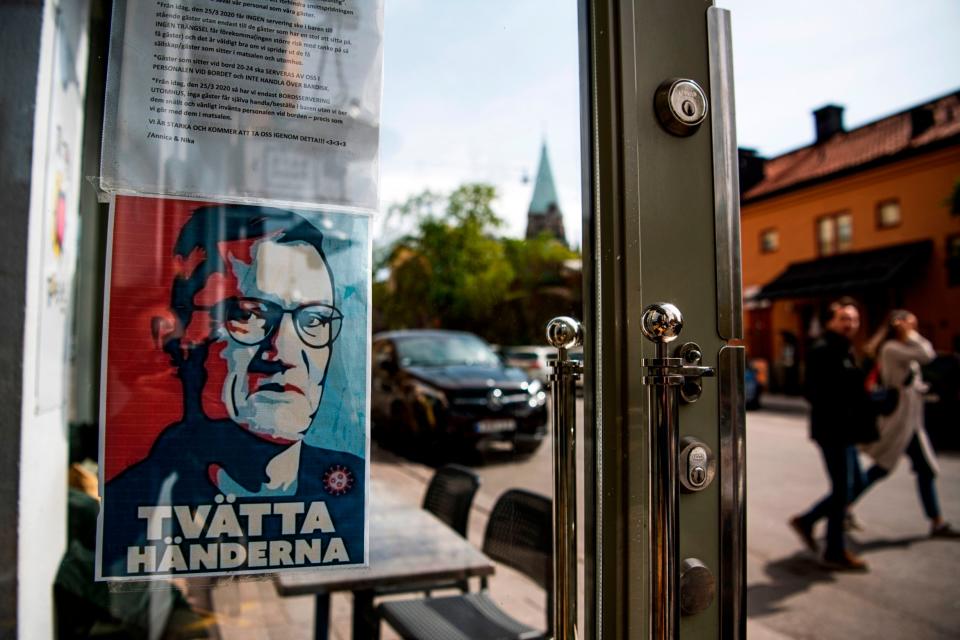 A portrait of Anders Tegnell hangs in the entrance to a restaurant to instruct people to wash their hands in Sodermalm (AFP via Getty Images)