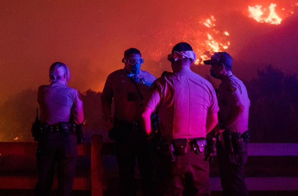 Local law enforcement standby to give mandatory evacuation orders to residents in Thousand Oaks, Calif. as the Wooolsey fire burns over 8,000 acres on Nov. 8.