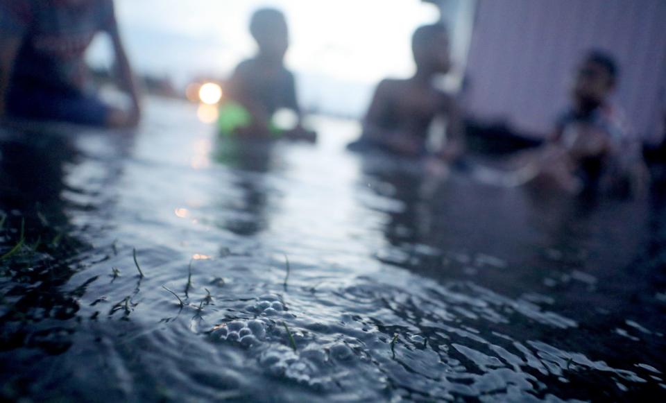 Bubbles percolate from the ground in floodwaters occurring near high tide in a low lying area near the airport on November 27, 2019 in Funafuti, Tuvalu.