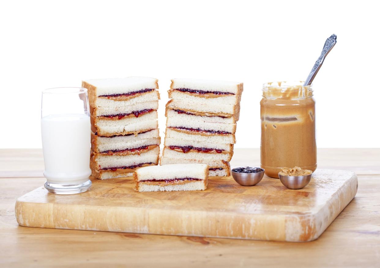 Stacks of peanut butter and jelly sandwiches on white