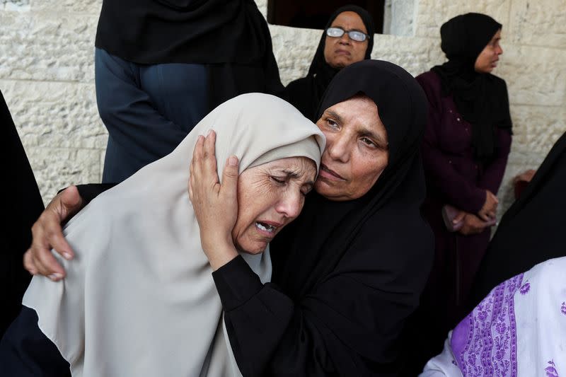 Palestinians mourn loved ones killed in Israeli strikes, in Deir Al-Balah