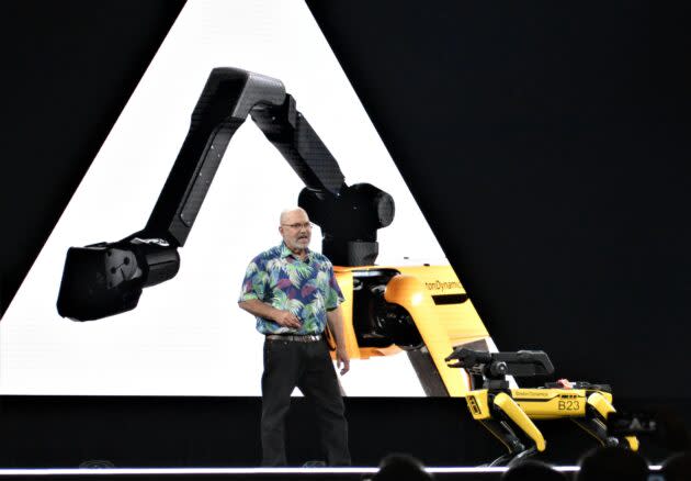 Boston Dynamics’ four-legged SpotMini robot may look scary as it shares the stage with company founder and CEO Marc Raibert at Amazon’s re:MARS conference in Las Vegas in June. But a report published this month praises Boston Dynamics’ owner, SoftBank, for confirming that it won’t develop technologies that could be used for military purposes. (GeekWire Photo / Alan Boyle)