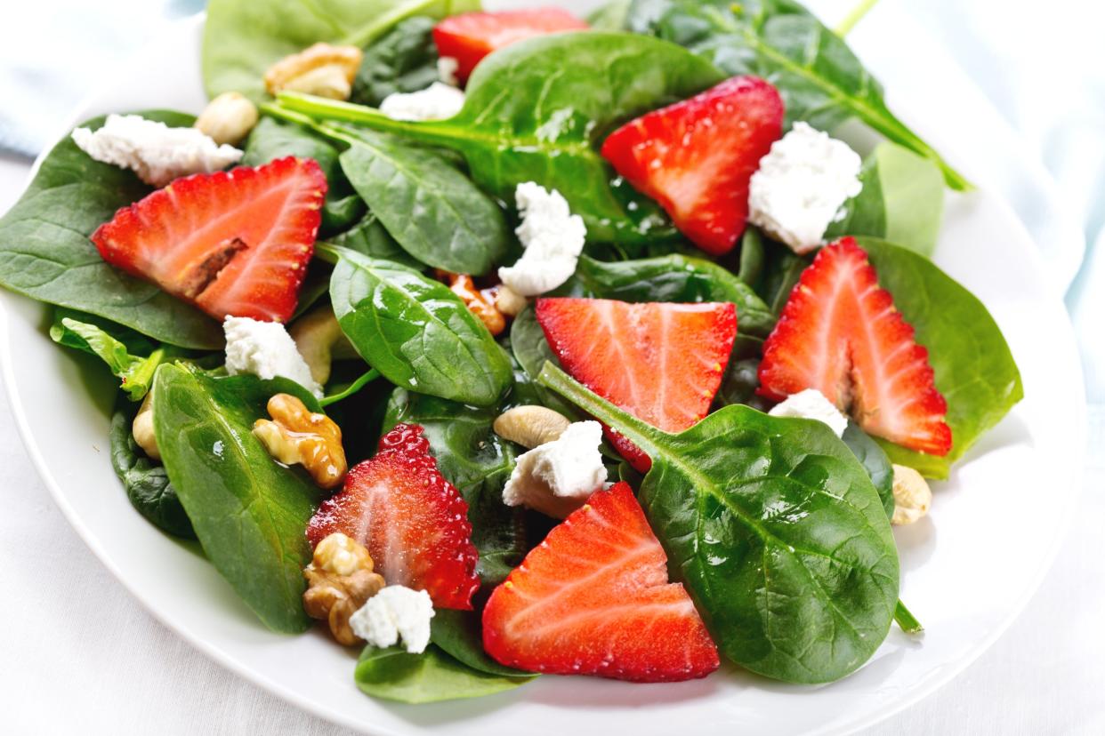 Salad with strawberry, spinach leaves and feta cheese