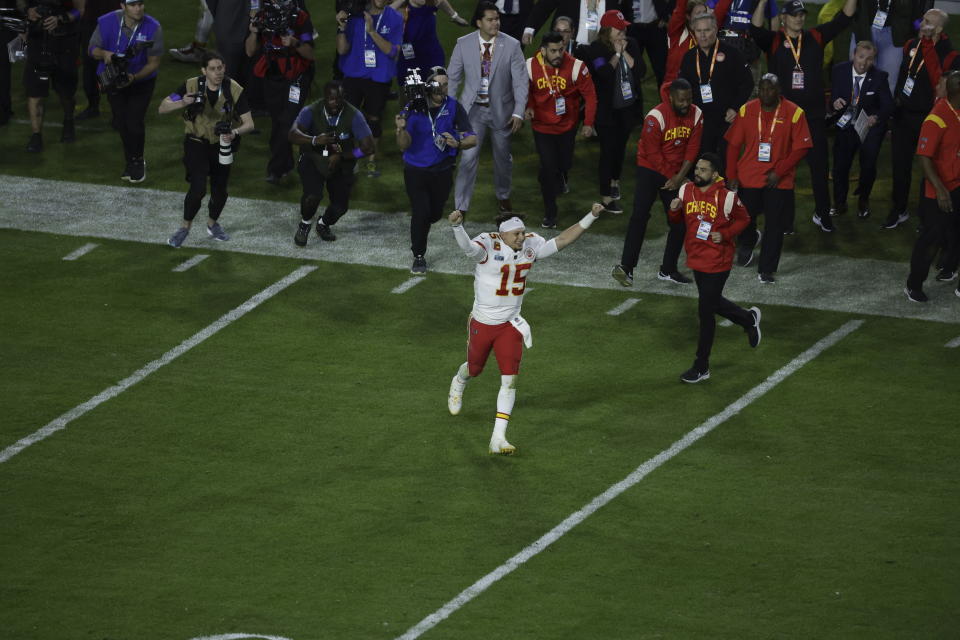 Kansas City Chiefs quarterback Patrick Mahomes (15) runs onto the field after winning the NFL Super Bowl 57 football game, Sunday, Feb. 12, 2023, in Glendale, Ariz. (AP Photo/Adam Hunger)