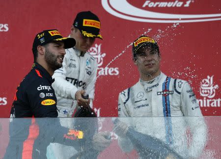 Formula One - F1 - Azerbaijan Grand Prix - Baku, Azerbaijan - June 25, 2017. Red Bull Racing Formula One driver Daniel Ricciardo of Australia, second placed Mercedes' Valtteri Bottas and third placed Williams' Lance Stroll celebrate. REUTERS/David Mdzinarishvili