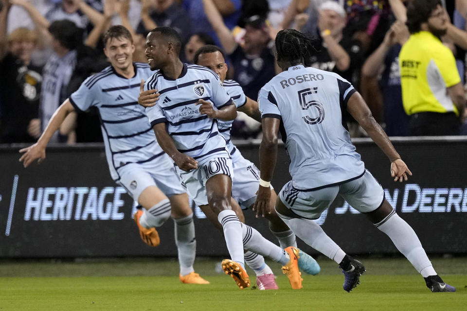 Sporting Kansas City midfielder Gadi Kinda (10) celebrates with teammates after scoring a goal during the first half of an MLS soccer match against FC Dallas Wednesday, May 31, 2023, in Kansas City, Kan. (AP Photo/Charlie Riedel)