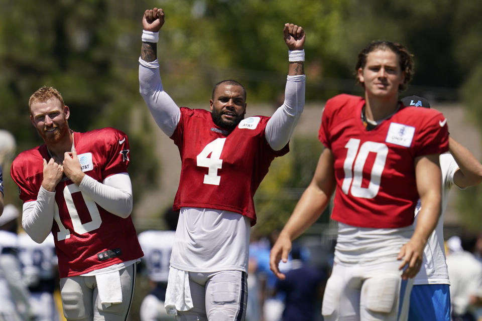 Dallas Cowboys quarterback Cooper Rush, left, quarterback Dak Prescott (4), and Los Angeles Chargers quarterback Justin Herbert, right, participate in drills during a combined NFL practice at the Los Angeles Rams' practice facility in Costa Mesa, Calif. Thursday, Aug. 18, 2022. (AP Photo/Ashley Landis)