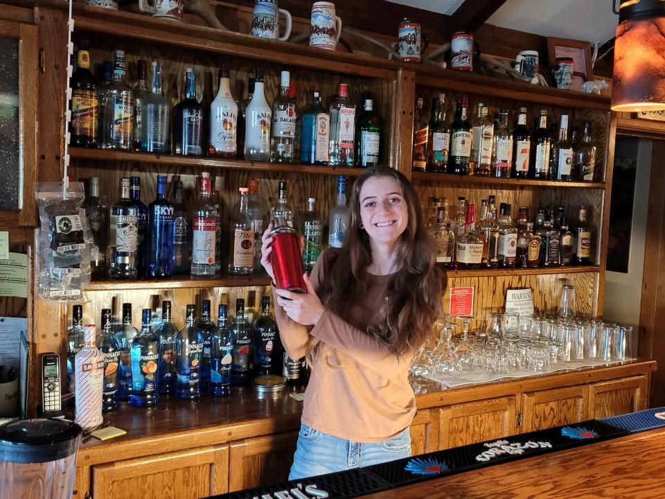 Hannah Apple tends bar at the Rex Club in Burney.