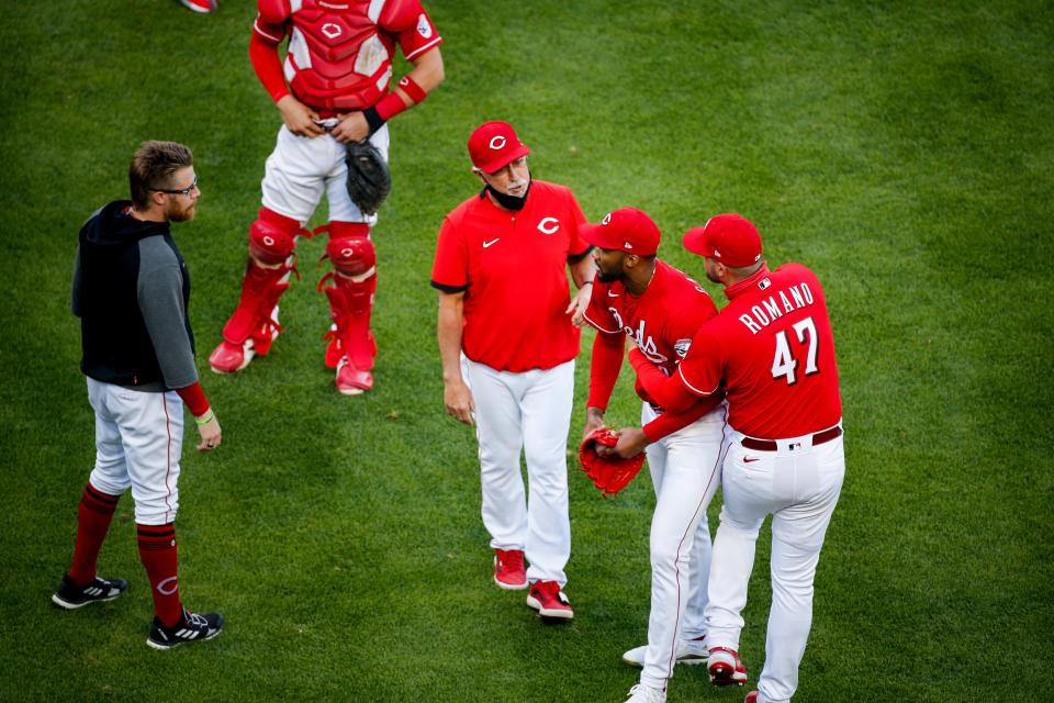 Reds pitcher Sal Romano (47) holds back Amir Garrett as the benches clear against the Chicago Cubs.